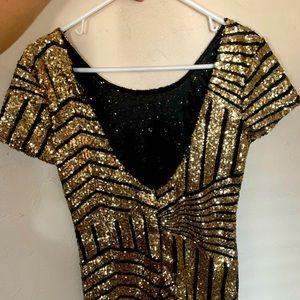 Short, low back dress. Juniors medium-large. Worn one evening. Great condition.